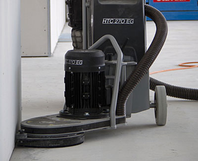 HTC concrete edge floor grinder in use